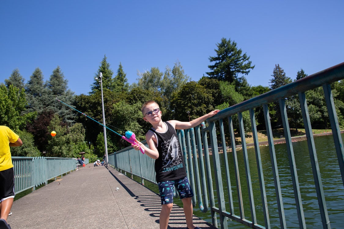 A boy fishing from the pier at Blue Lake Regional Park