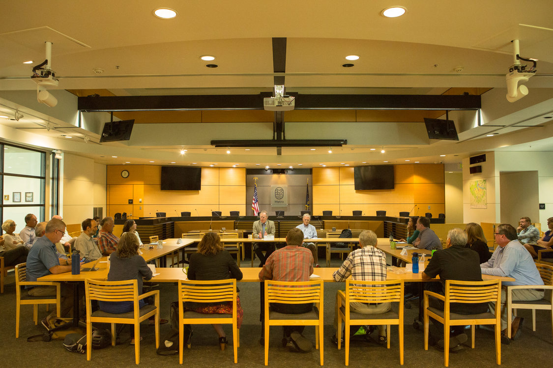 Photo of people sitting around tables during a discussion