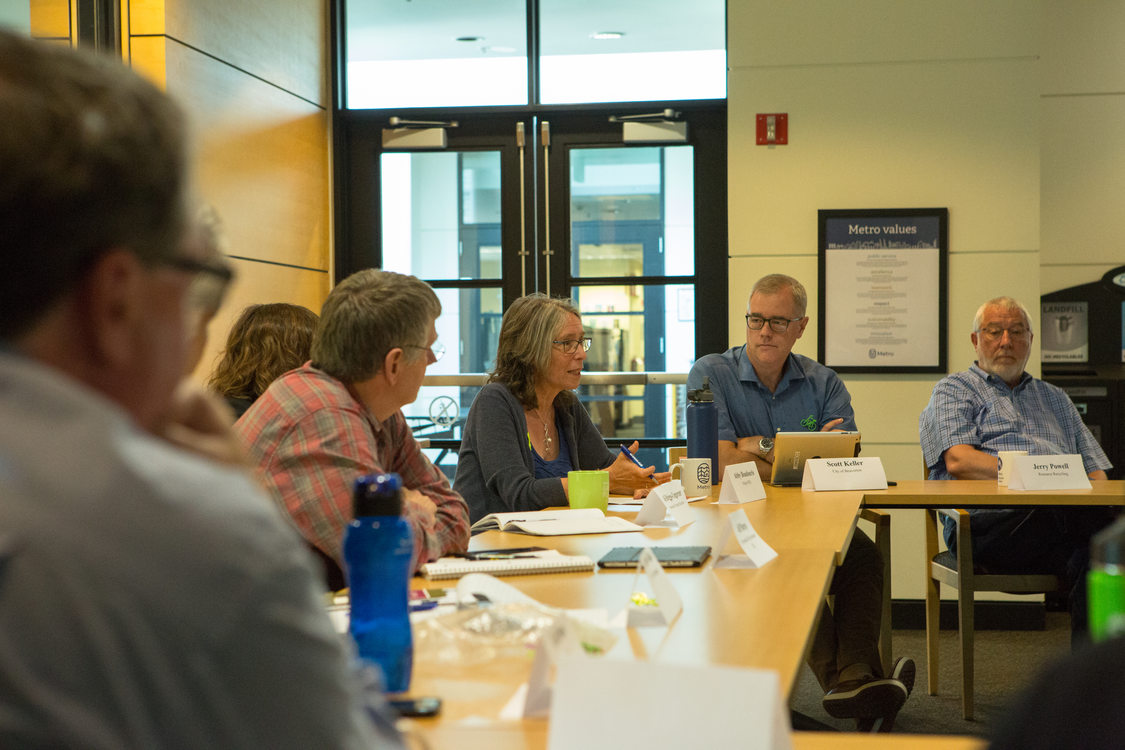 Photo of people sitting around tables during a discussion