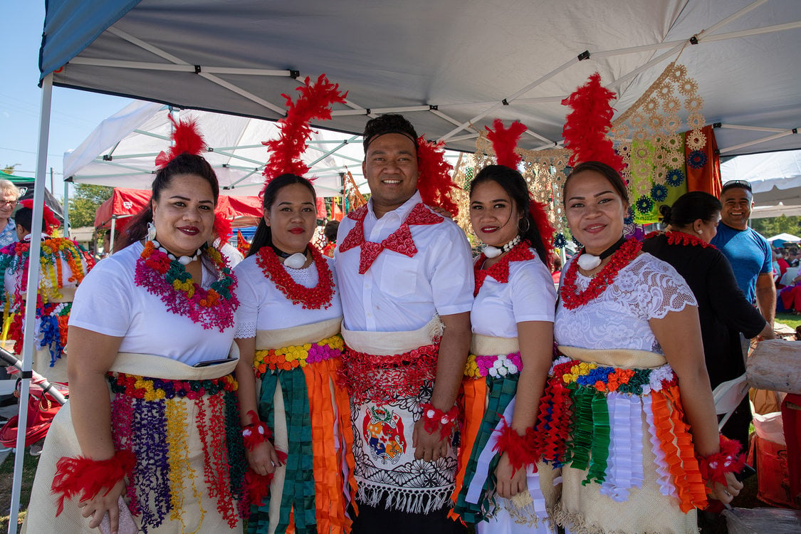 Tongan community members wear bright ceremonial wear