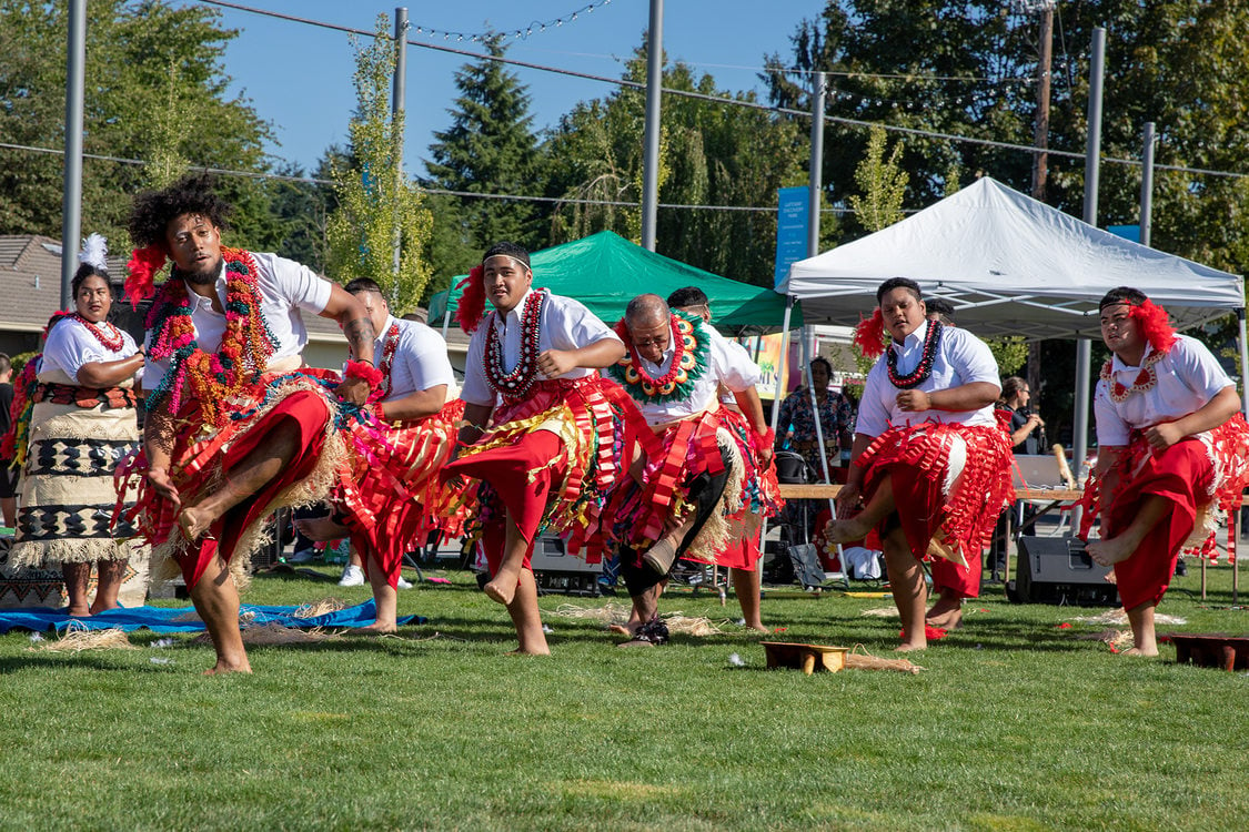 A group of performers dances on stage at Tonga Day at Gateway Discovery Park.
