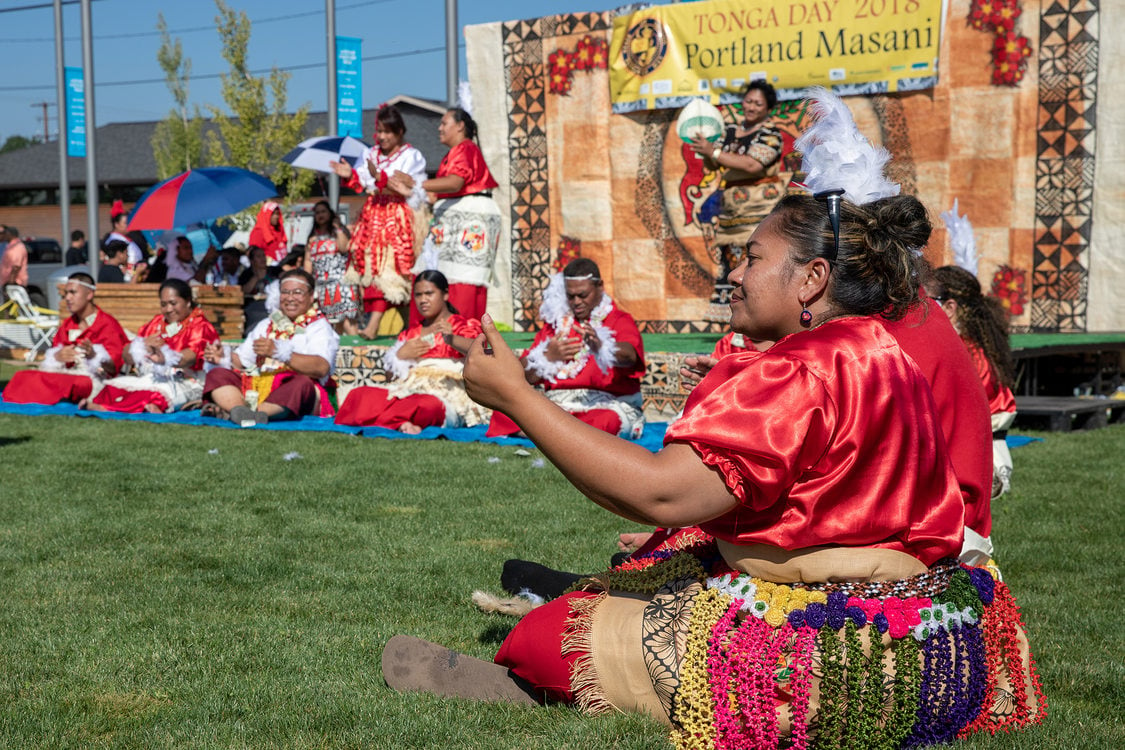 Tongan singing performance where performers dance while sitting and singing.