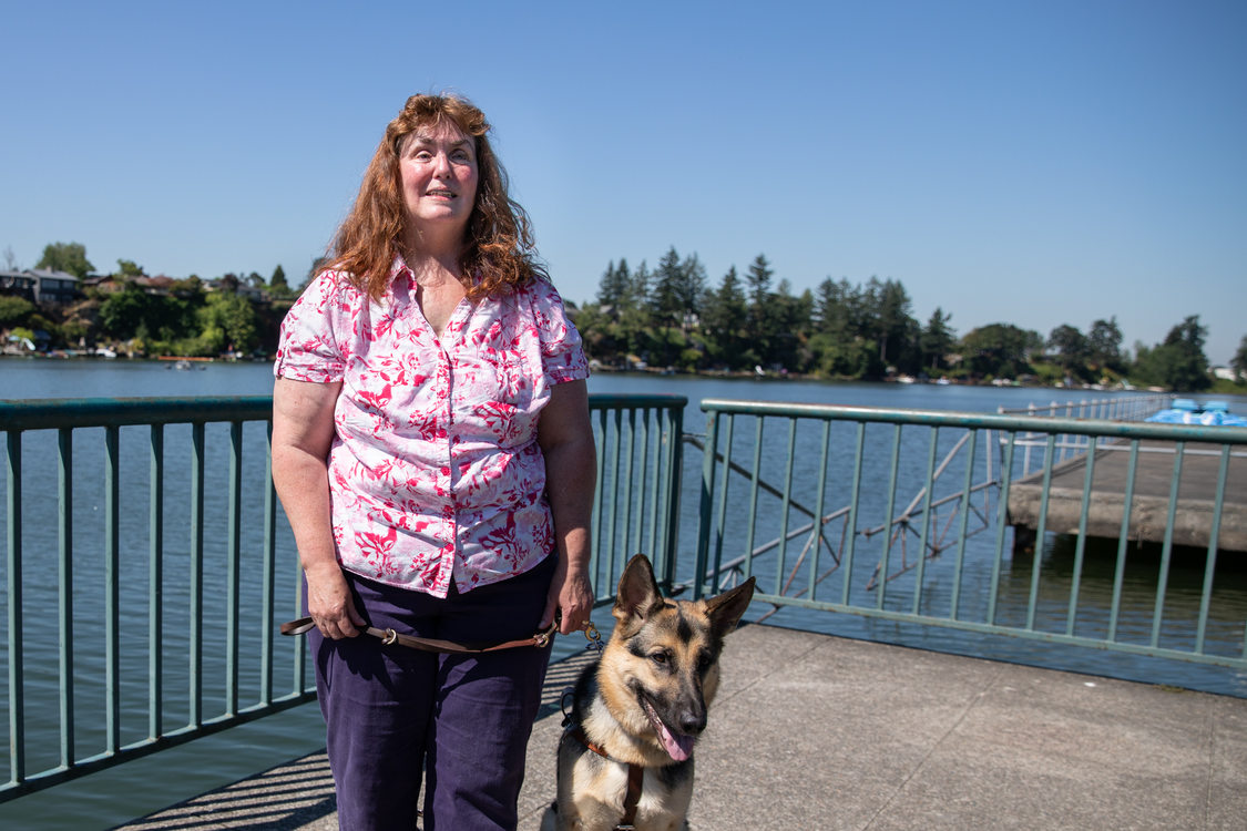 Patricia Kepler with her guide dog on the fishing dock at Blue Lake Regional Park 