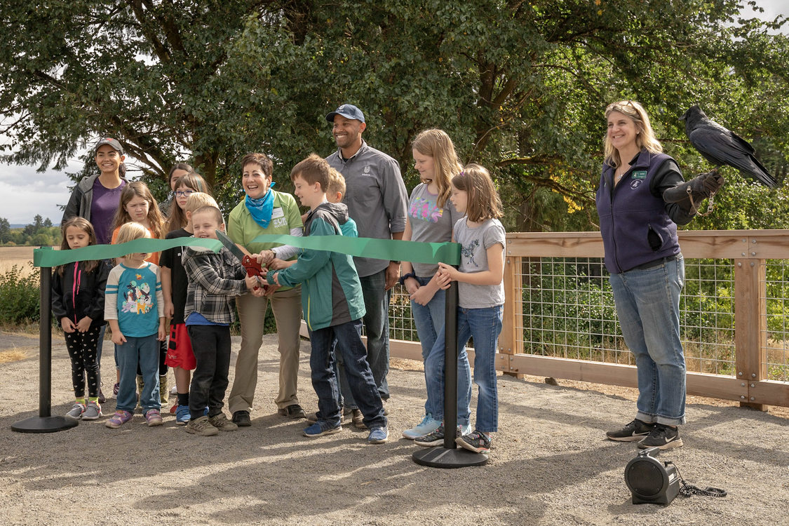 Metro councilor Kathryn Harrington and director of parks and nature, John Blasher invite children from the audience to join them as they cut the ribbon on opening day at Killin Wetlands Nature Park.