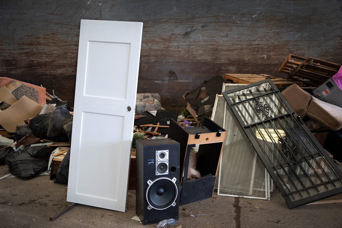 a wooden house door and stereo speakers join the pile to be sorted at Metro Central