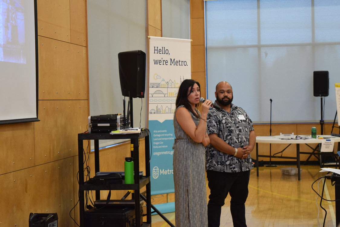 Woman with microphone and man speaking to audience