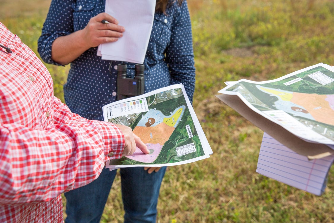 People looking at a map of St. Johns Prairie