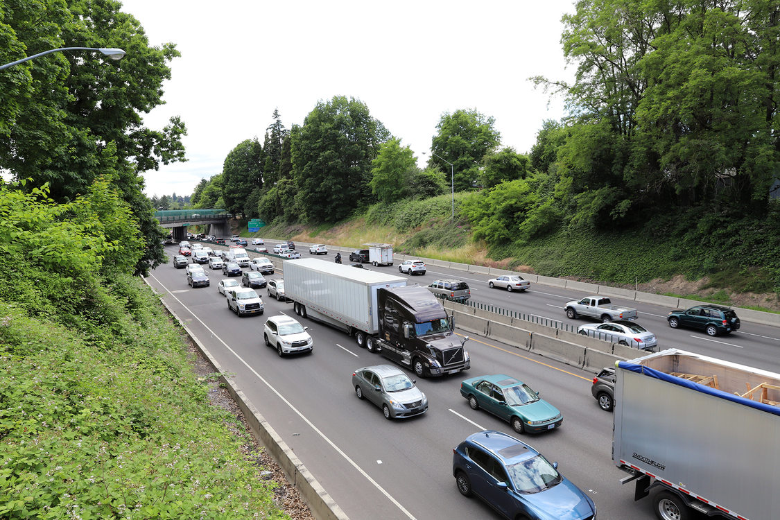 Freight trucks drive on Interstate 5