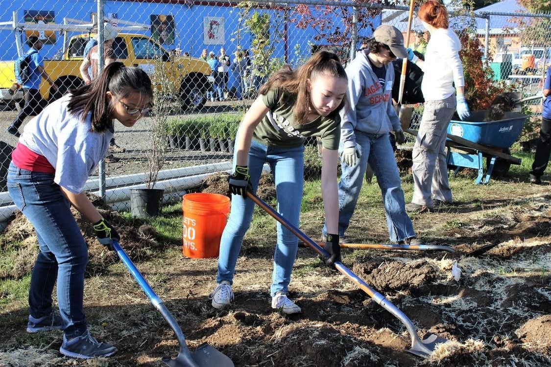 photo of children planting trees at M&M Marketplace