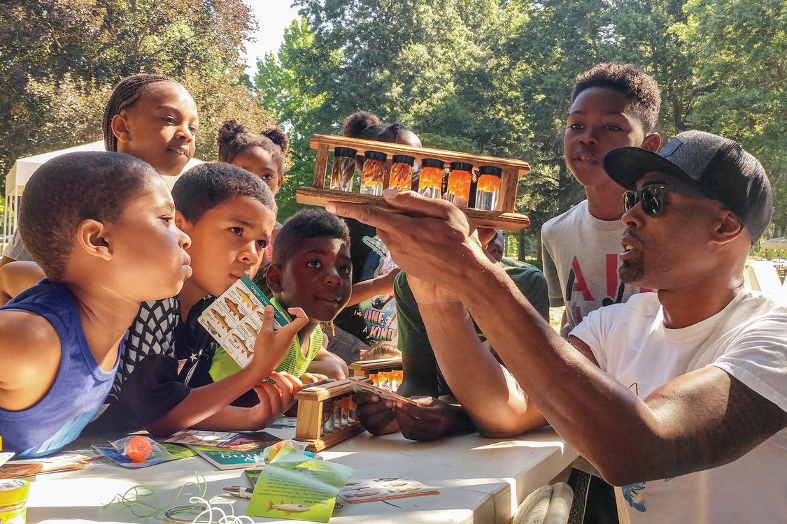 Dishaun Berry of Get Hooked teaches campers from Camp ELSO about the life stages of fish at Blue Lake Regional Park.