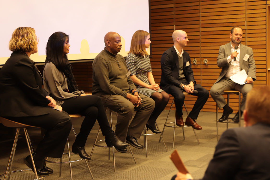 A panel of six take turns speaking at the launch party in December.