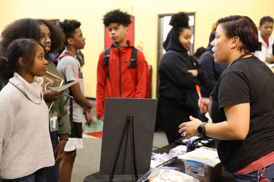 woman talking to students at SEI trades fair