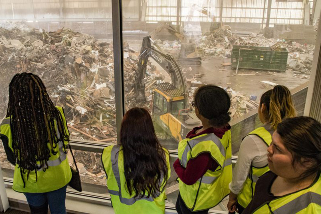 garbage and recycling interns touring a transfer station