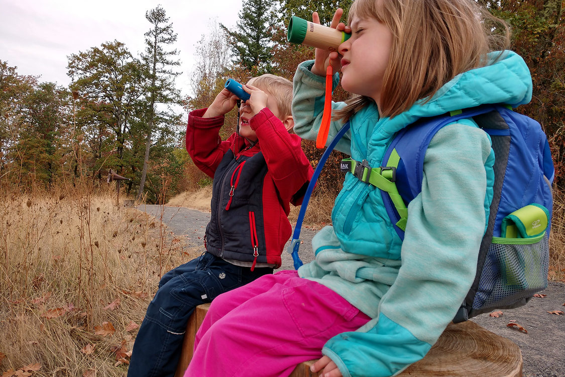 Two children look through spyglasses at Cooper Mountain Nature Park.