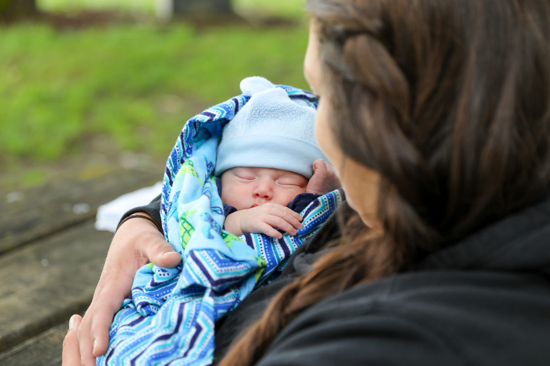 baby cradled in woman's arms