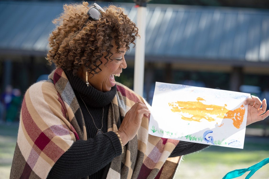 A woman shows her salmon etching.