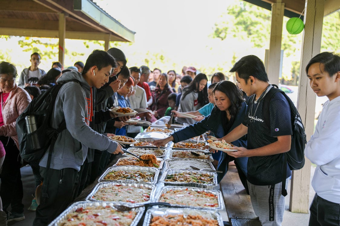 line of people getting asian food