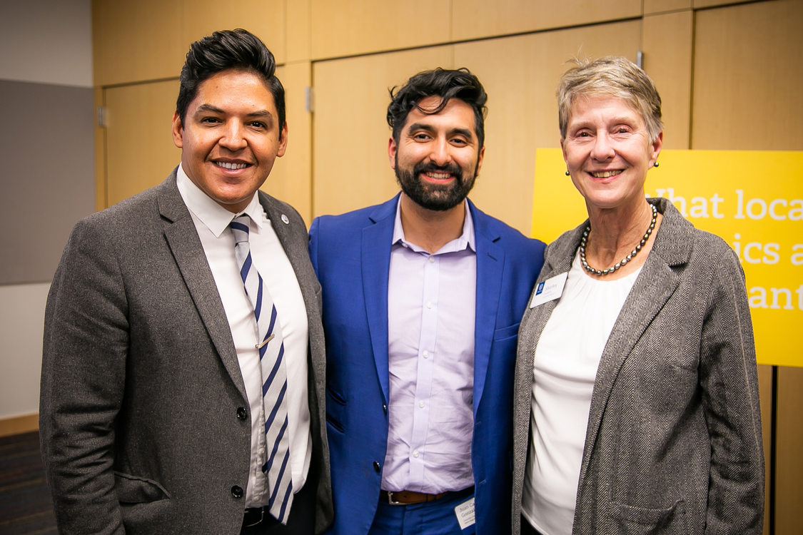 Metro councilors Juan Carlos Gonzalez and Shirley Craddick standing with a community member at a conference