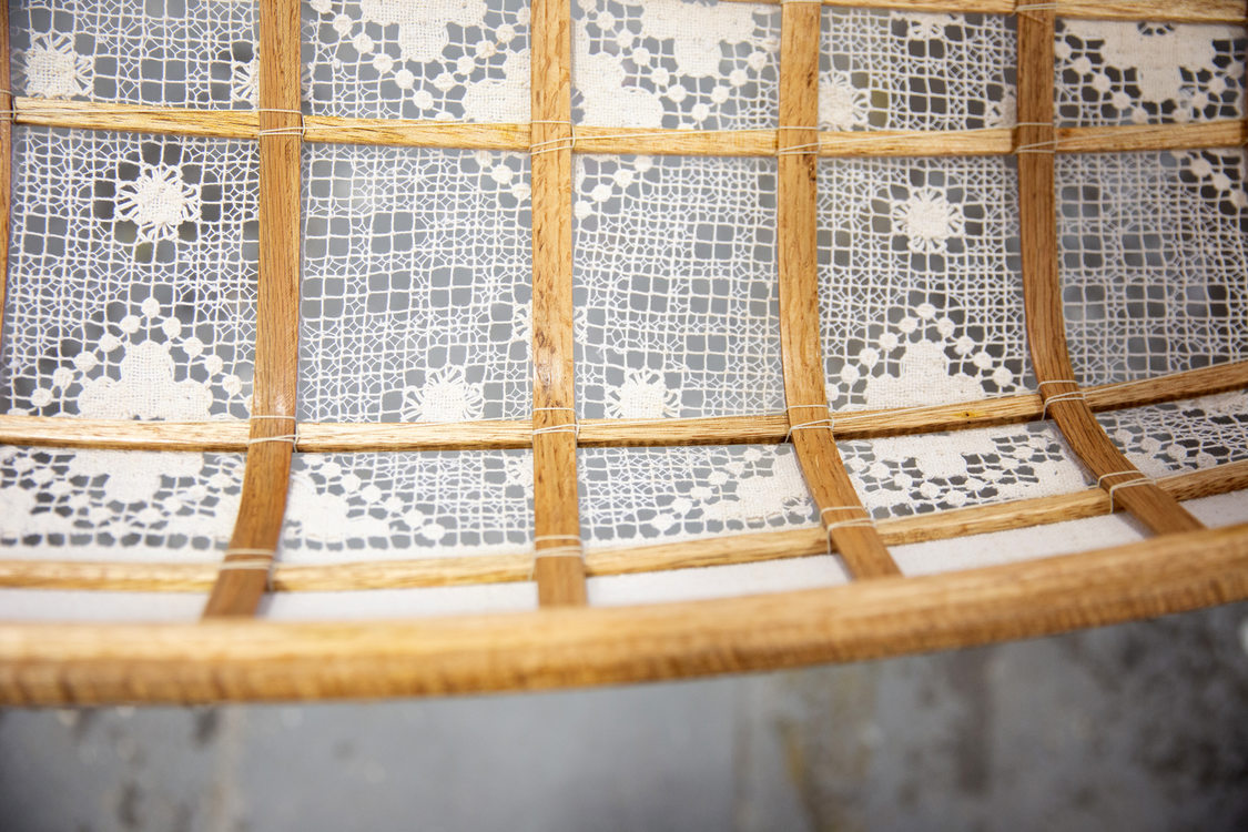 detail shot of a GLEAN artists' work incorporating discarded lace and found wood