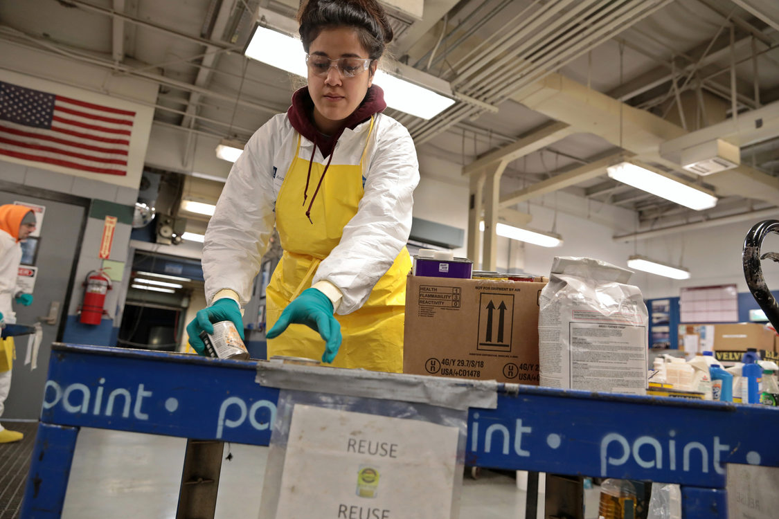 Annelise Tuitavuki sorts through paint at Metro South Hazardous Waste Facility