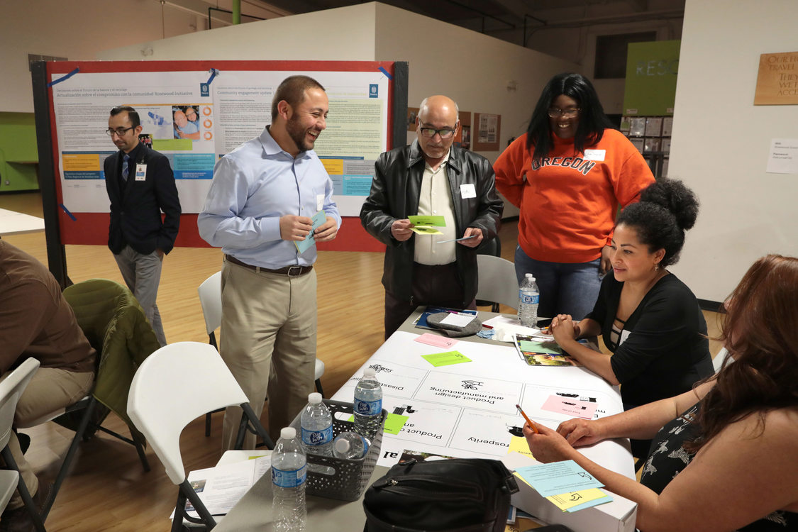 Community members laugh as they participate in a planning meeting