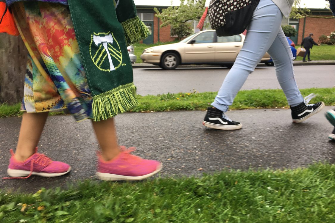 Middle school students walk along a completed sidewalk