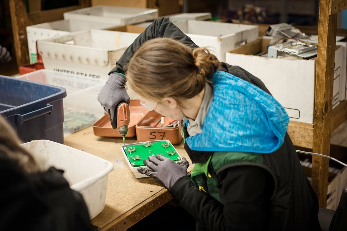 Free Geek volunteer prepares electronics for recycling.