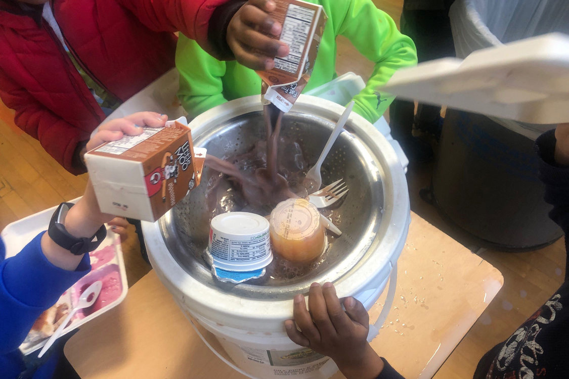 Children at school collect food scraps