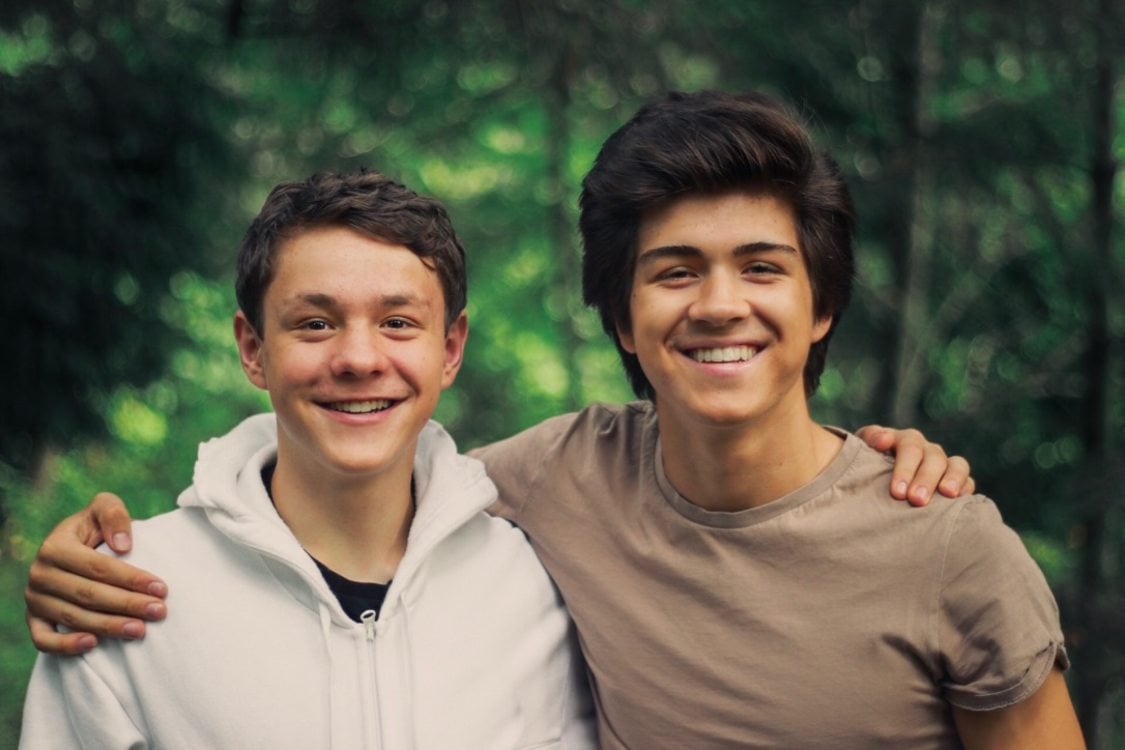 two boys in a shoulder-to-shoulder embrace