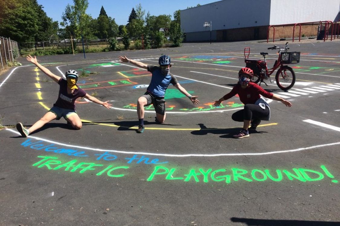 volunteers pose to celebrate the traffic playground they just finished installing at Harrison Park