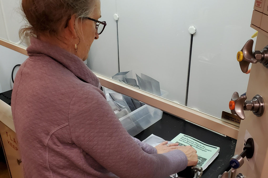 Marsha sealing seed envelopes at PSU’s seed bank.