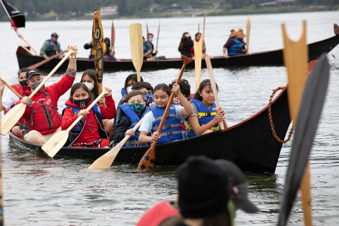 Portland All Nations Canoe Family rowing in a canoe together in the Columbia River