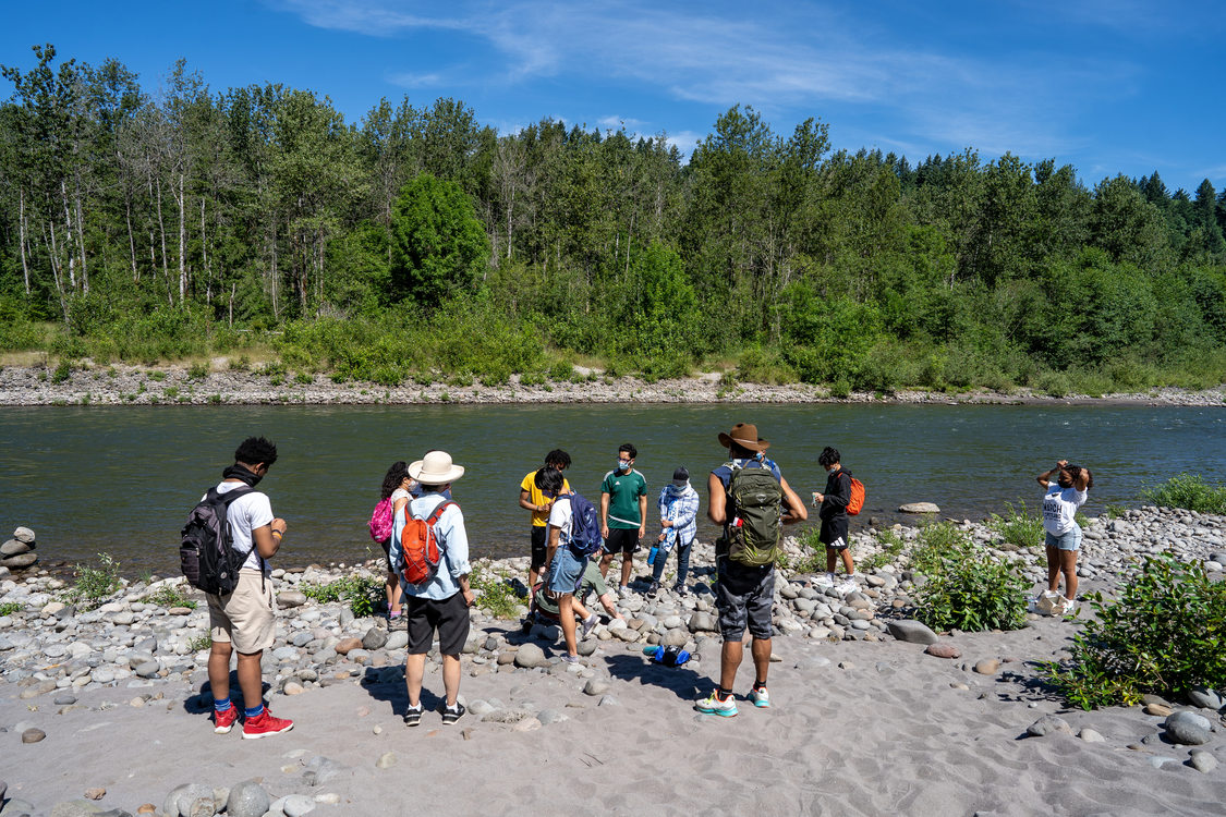 A group of training staff from Metro gather along the banks of the Sandy River in Oxbow Regional Park