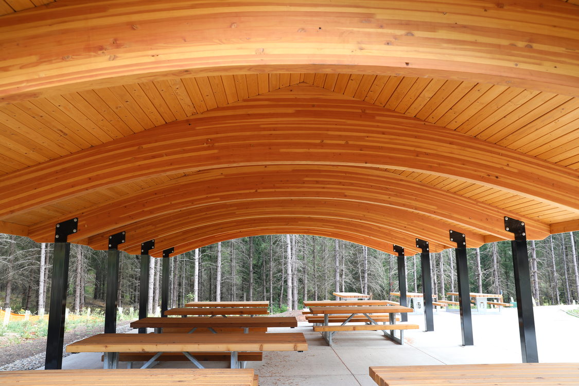 Heron Shelter picnic area at Chehalem Ridge Nature Park, showing several accessible picnic tables under a wood-trussed canopy shelter