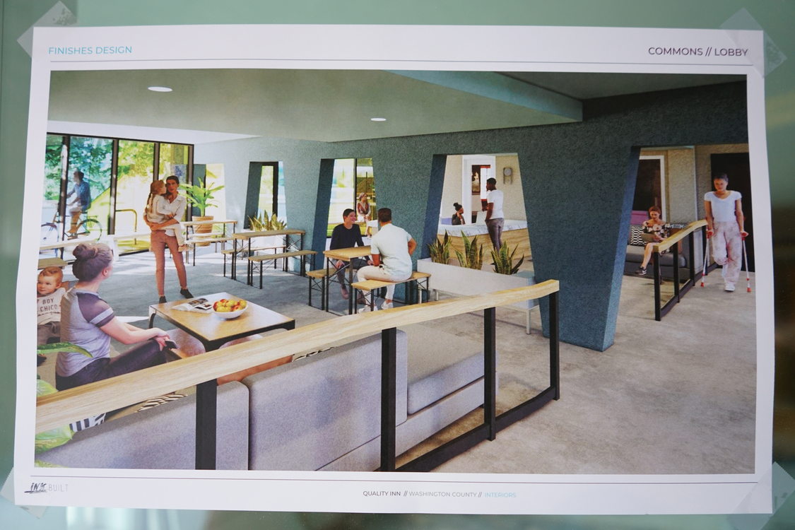An architectural rendering of the completed commons area of Aloha Inn, showing the walls painted in soothing shades of blues. The printed rendering is taped to a wall as part of the construction site visit and tour for this Metro News story on Aloha Inn.