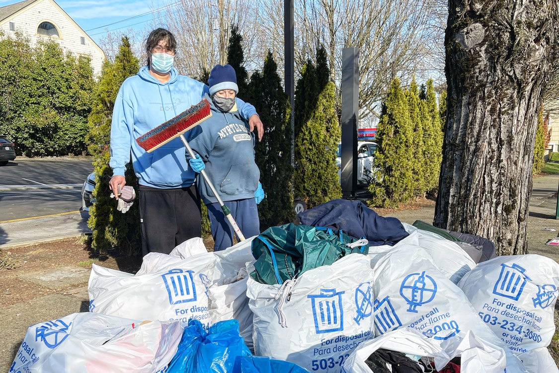 An image of volunteers in front bags of trash they collected.