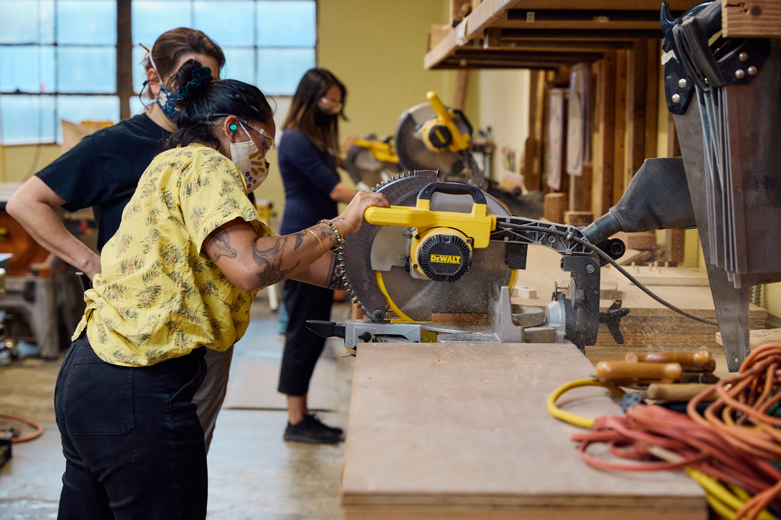 Image of a woman using a radial arm saw 