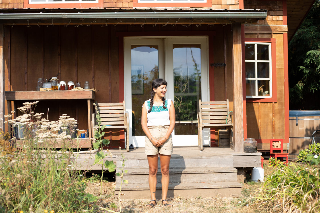 Lara Pacheco of Atabey Medicine standing in front of a home
