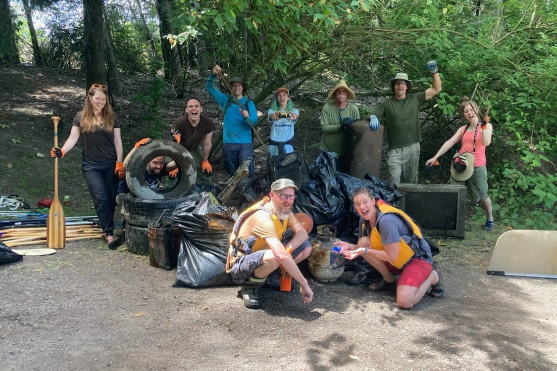 An image of a group of volunteers in front of trash they collected
