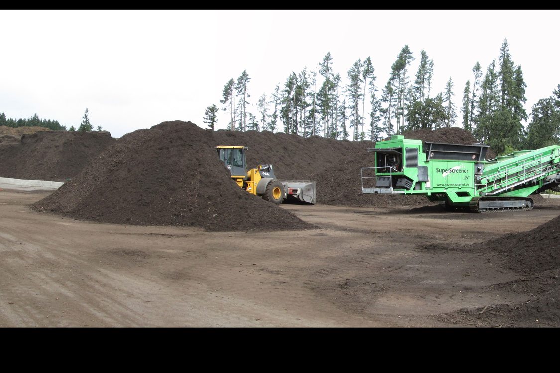 An image of compost piles and equipment