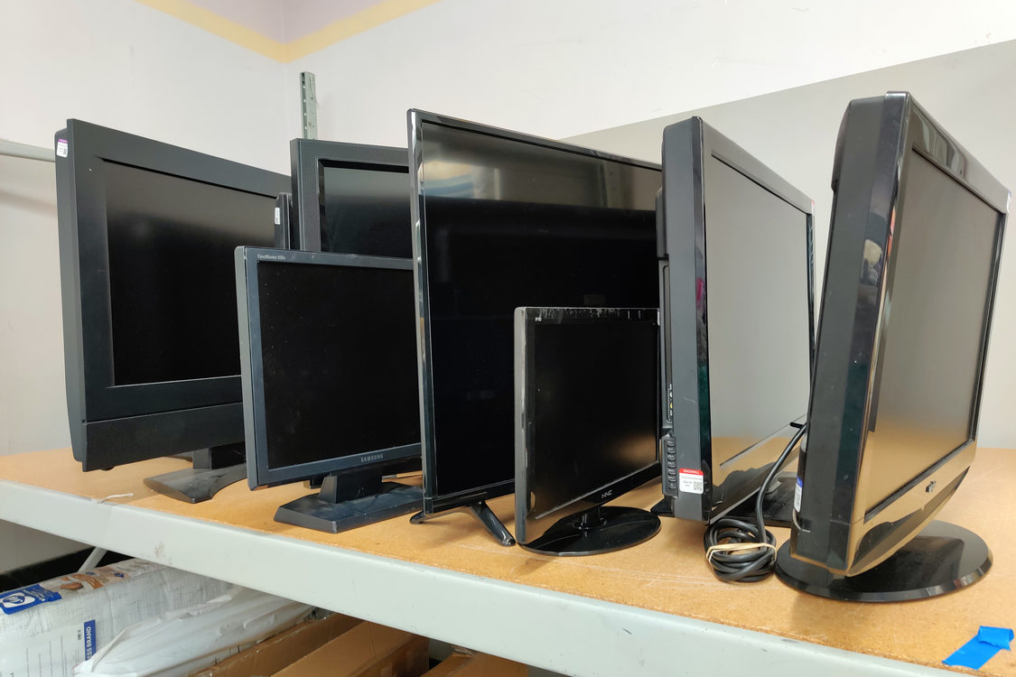 Used television sets on a shelf in a second hand store
