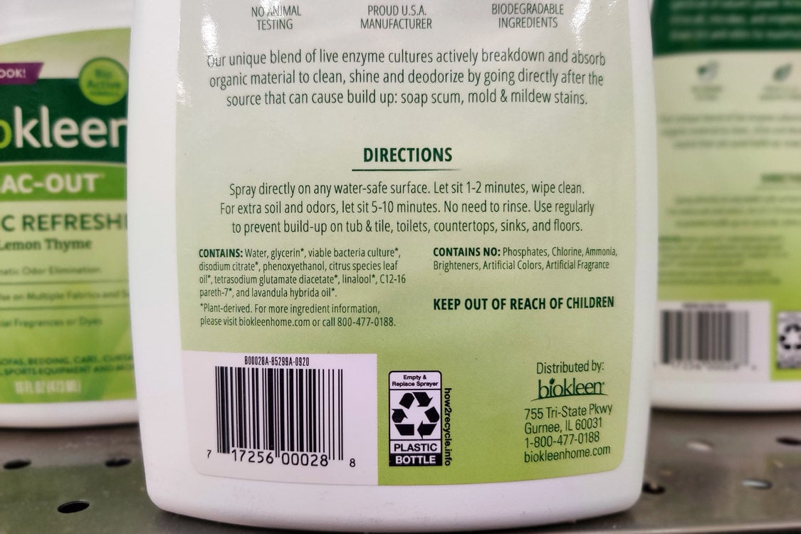 The bottom half of white bottle of cleaner with label that fades from green to white. The cleaning product shows directions and ingredients but no signal word, indicating it is a safer cleaner
