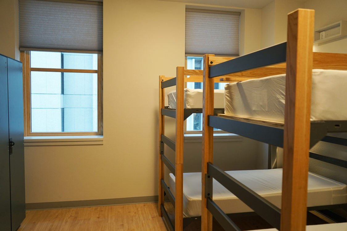 Bunk beds in a room with two windows