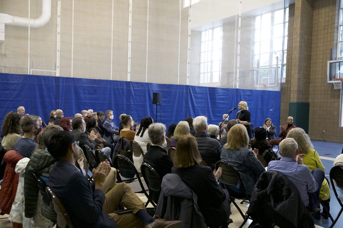 Metro Council President Lynn Peterson speaks before a large group of people in a gymnasium.