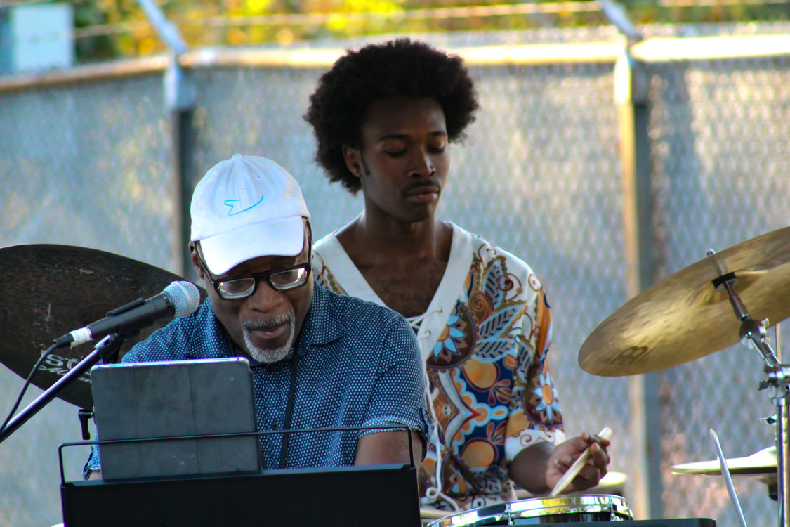 A keyboardist and drummer playing jazz music at the afro-topia pop-up event