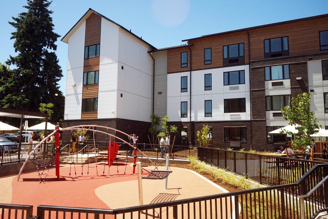 Apartment complex with playground in the foreground.