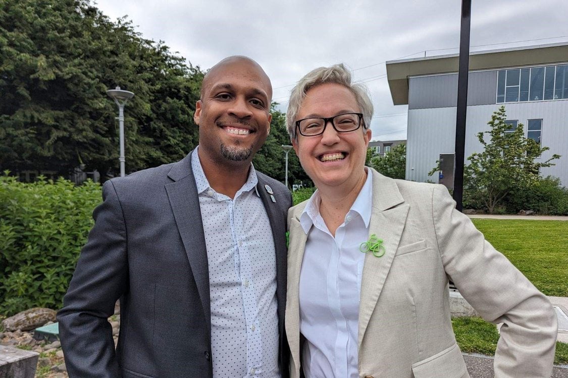 Metro Councilor Ashton Simpson stands alongside Oregon Governor Tina Kotek at a transportation conference in Portland.