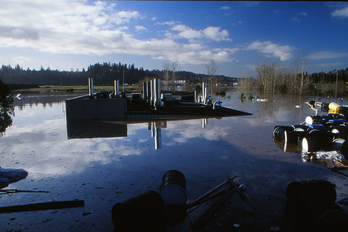 The roofline of the Metro South's hazardous waste facility is barely above the waterline of a flood