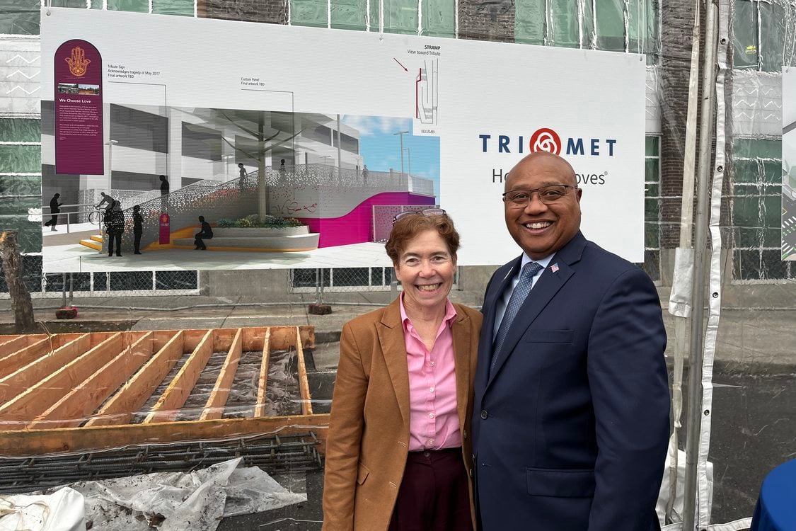 Metro Councilor Mary Nolan stands alongside Sam DeSue in front of a construction billboard for the groundbreaking of Hollywood Hub affordable housing.