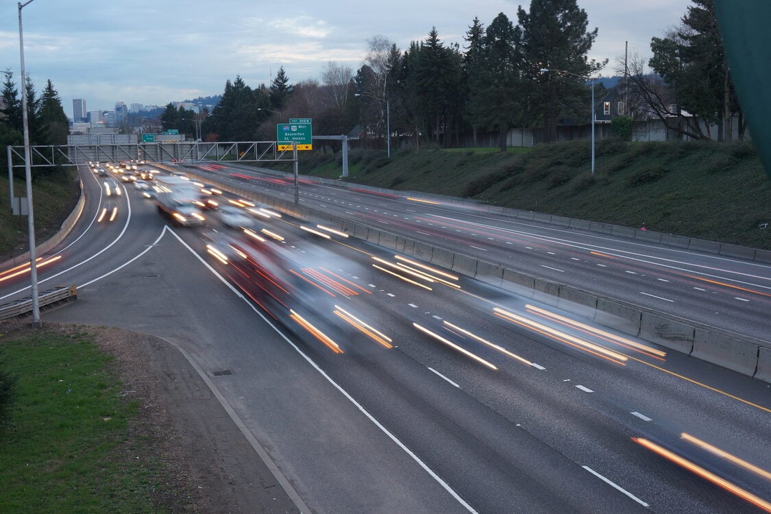 An aerial view of a highway with traffic on both sides
